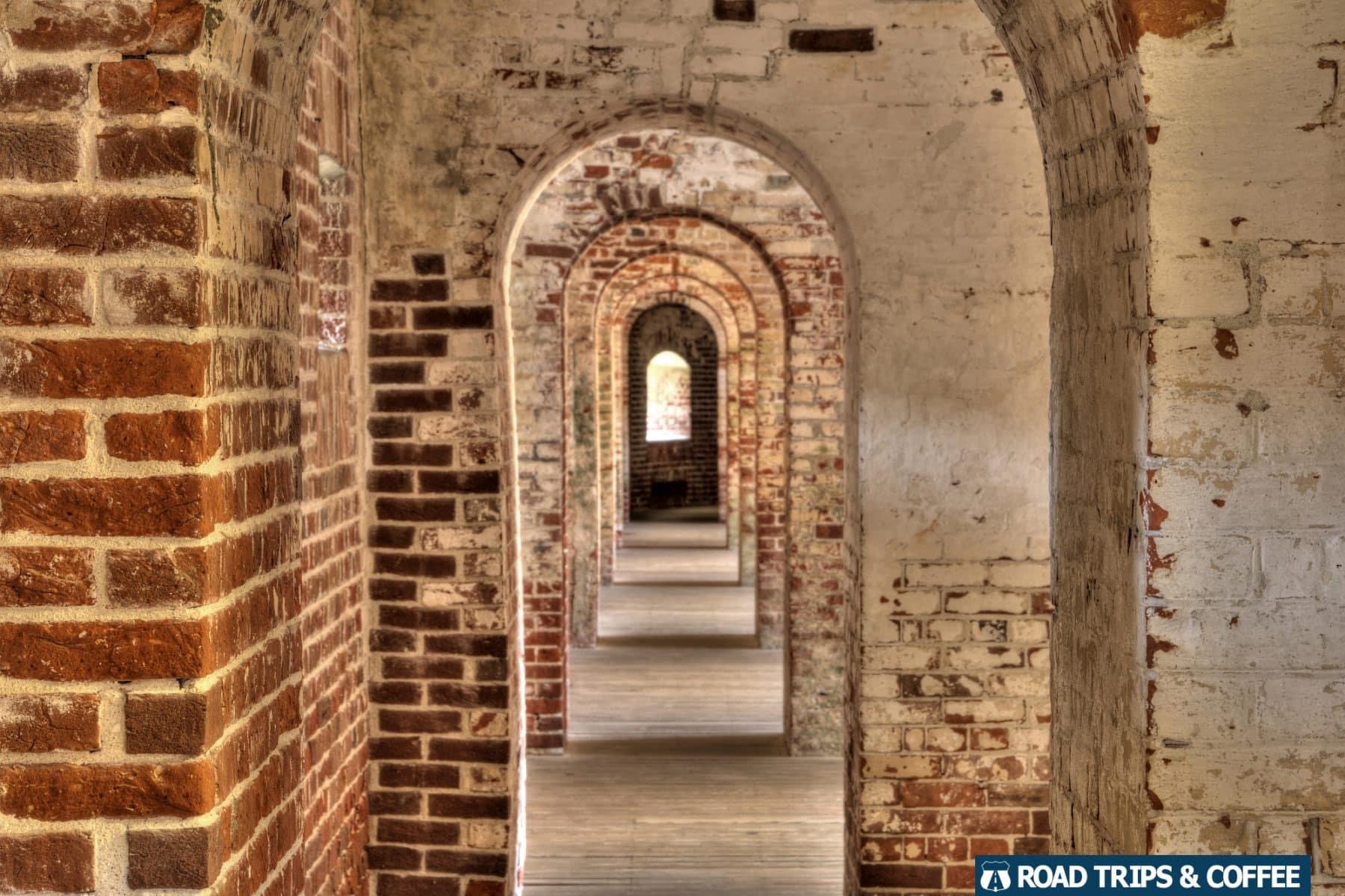Arched brick doorways, one after another, connecting the rear section of rooms inside Fort Macon State Park in Atlantic Beach, North Carolina