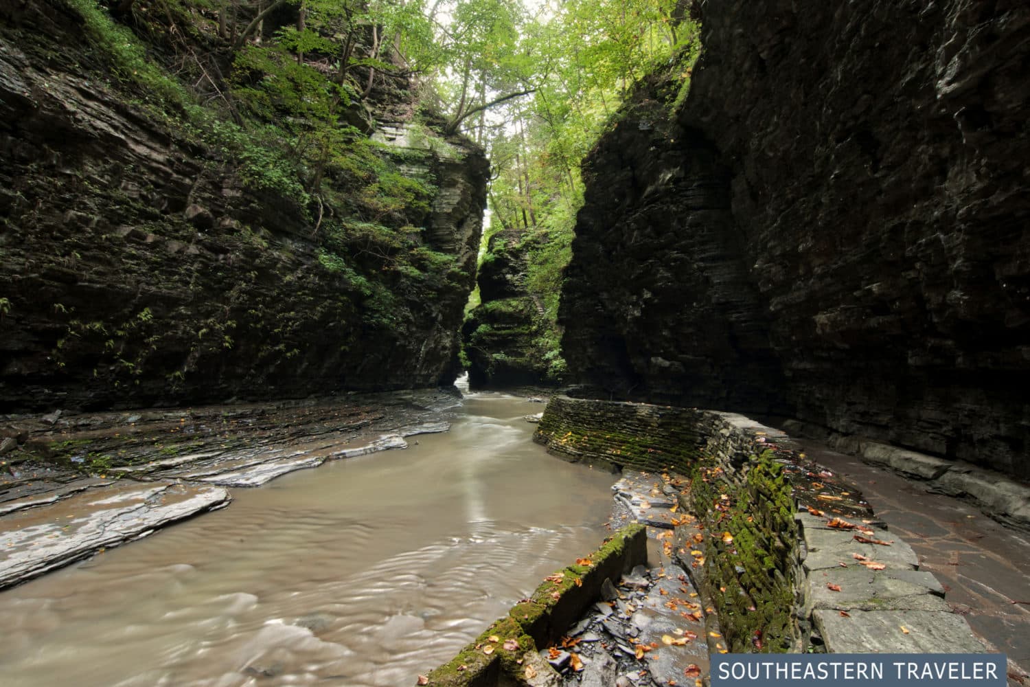 A stone trail runs alongside a river through the gorge at Watkins Glen State Park in New York