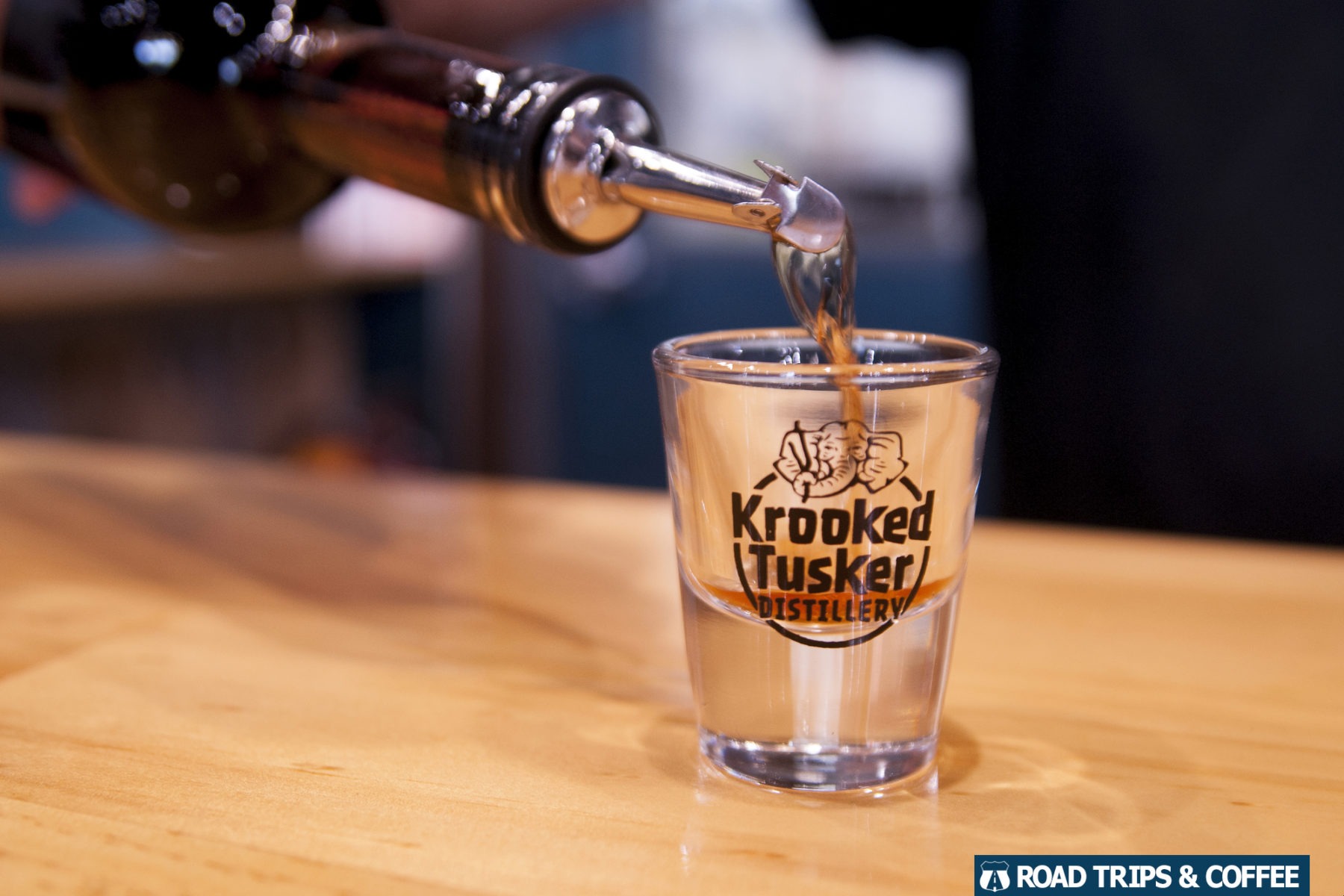 Pouring a shot of bourbon into a sample glass at the Krooked Tusker Distillery in Hammondsport, New York