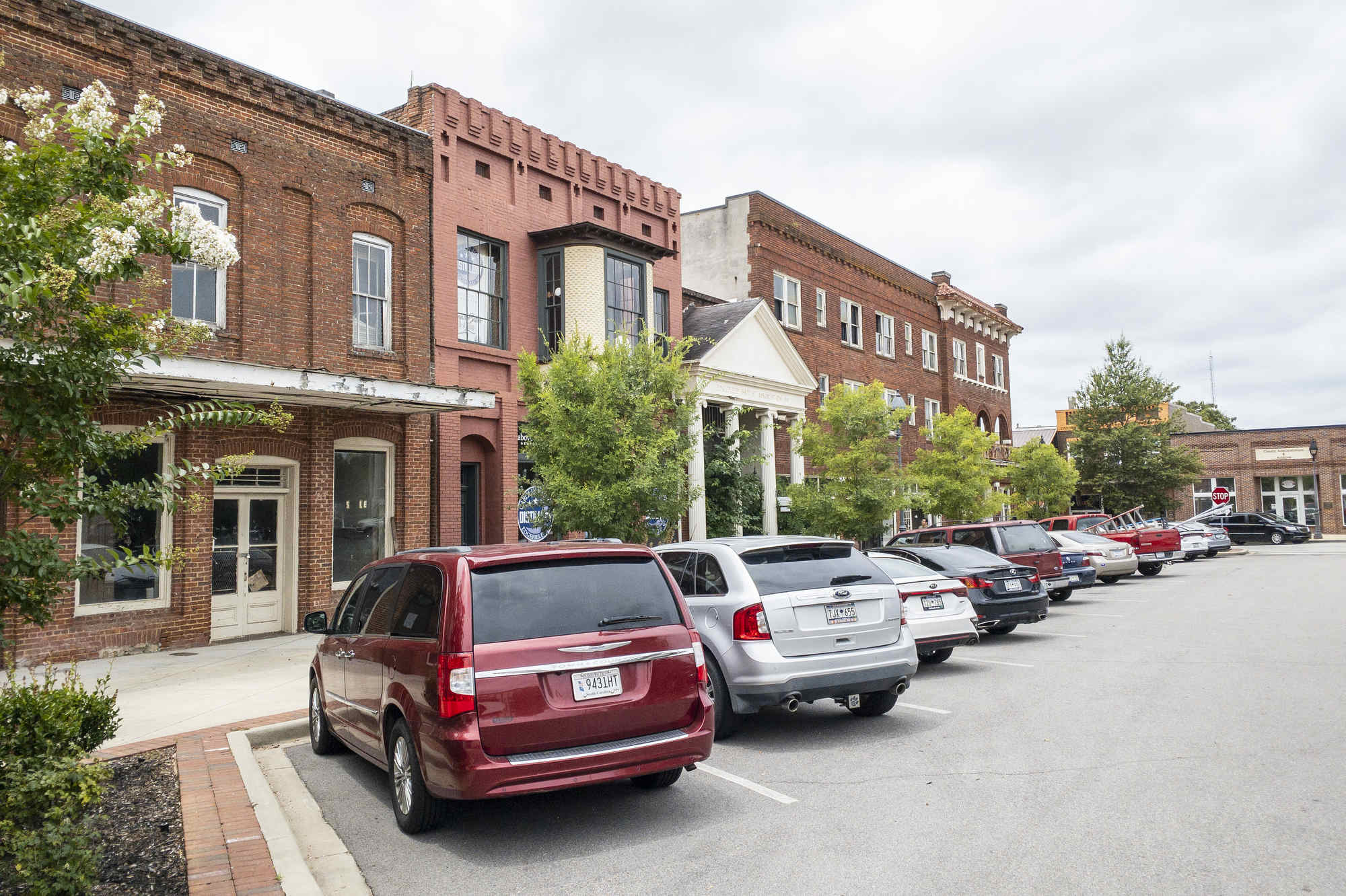Cars parked in front of brick buildings in downtown Edgefield, South Carolina.